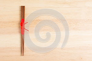 Japanese wooden chopsticks wrapped in red paper and red rope on