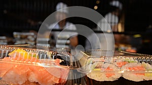 Japanese workers prepare Sushi rolls