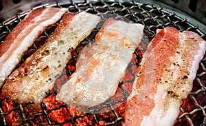 Japanese Yakiniku Marinated Pork Belly Slices on a Coal Grill.