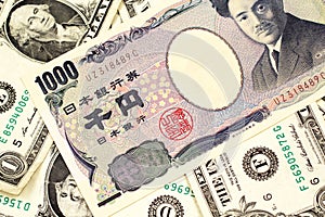 A Japanese yen bank note with American one dollar bills