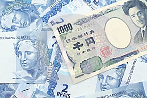 A Japanese yen bank note with Brazilian two reais bank notes