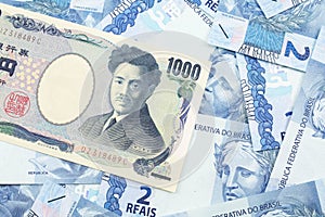 A Japanese yen bank note with Brazilian two reais bank notes