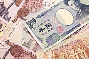 A Japanese yen bank note with Egyptian one pound bank notes