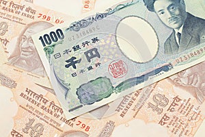 A Japanese yen bank note with Indian ten rupee bank notes