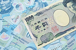 A Japanese yen bank note with Mexican twenty peso bank notes