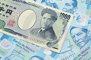 A Japanese yen bank note with Mexican twenty peso bank notes