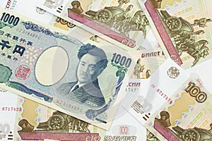 A Japanese yen bank note with Russian one hundred ruble bills