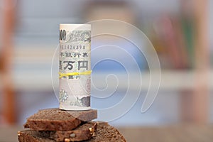 Japanese yen banknotes and black bread