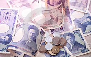 Japanese yen banknotes and Japanese yen coins for background image, Purple light concept