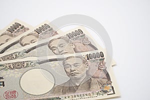 Japanese yen notes stretched out on white background.selective focus.