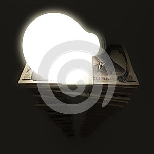 Japanese yen stack with shiny lightbulb
