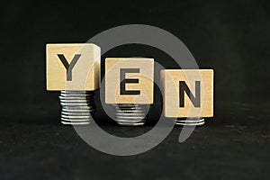 Japanese yen weakening, value depreciation and devaluation concept. Decreasing stack of coins