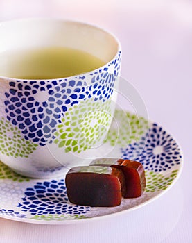 Japanese yokan sweets with green tea ceremony isolated on white