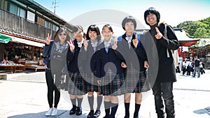 Japanese young schoolgirls posing with tourists