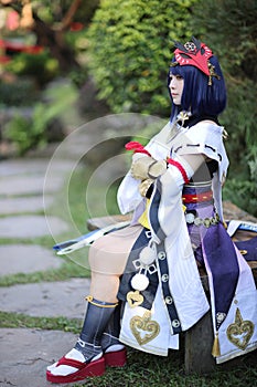 Japanese young woman hunter cosplay with bow on Japanese garden