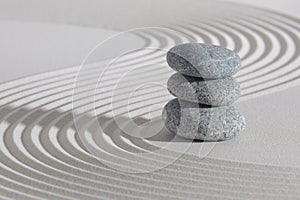 Japanese zen garden with stacked stones in sand