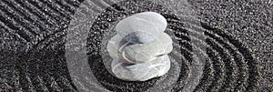 Japanese Zen garden with stone in textured sand