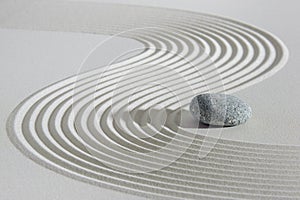 Japanese Zen garden with stone in textured sand