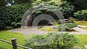 Japanese zen garden with stones surrounded by grass photo
