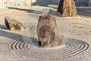 Japanese zen landscape garden, or karesansui, with raked sand or gravel to represent ripples in water. Kurikarafudoji