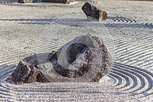 Japanese zen landscape garden, or karesansui, with raked sand or gravel to represent ripples in water. Kurikarafudoji