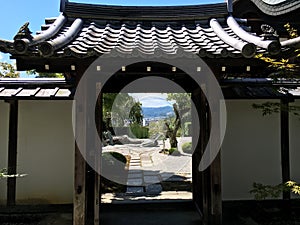 Japanese zen rock garden through the gate in Kyoto in summertime
