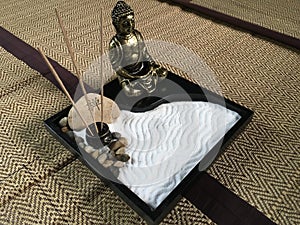 Japanese zen tray garden with bronze buddha statue photo