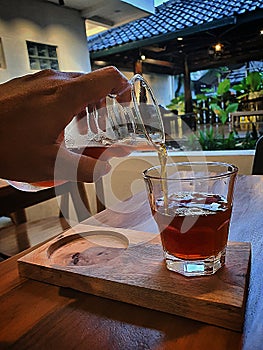 Japanesse coffee pouring to the glass oemago photo