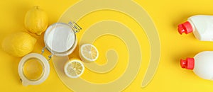 Jar of acid powder, lemons and detergents on yellow background