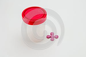 Jar for analysis, pills on a white background
