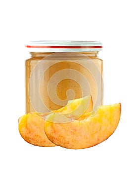Jar of baby puree and peach slice isolated on white