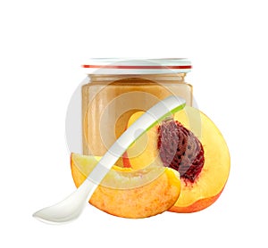 Jar of baby puree, spoon and peach slice isolated on white