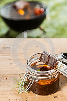 Jar of basting sauce for the meat on the BBQ