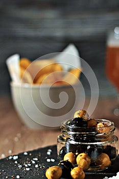 Jar of black and green olives, lined with aromatic herbs appetizers, snacks and pickles