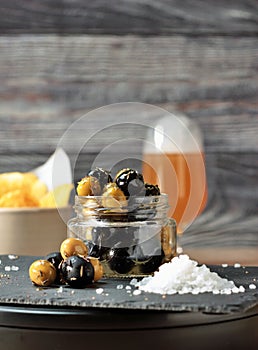 Jar of black and green olives, lined with aromatic herbs appetizers, snacks and pickles