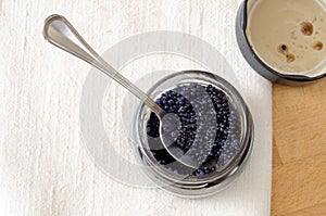 Jar of black lumpfish eggs on the table