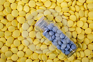 Jar of blue pills lies on other medicines. Drugs, painkillers, colds Closeup