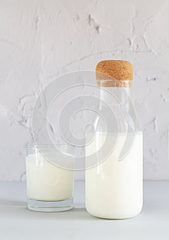 Jar or bottle of organic yogurt or kefir with glass