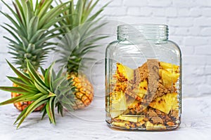 A jar of brown sugar and sliced pineapple,