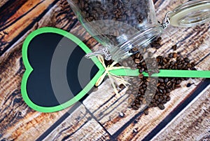 Jar of coffe beans and heart of blackboard.