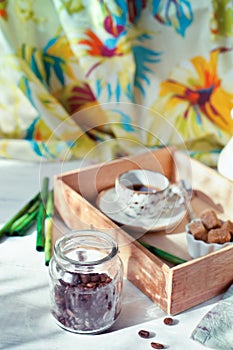 Jar of coffee beans set with a cup of coffee and accessories