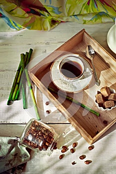 Jar of coffee beans set with a cup of espresso and accessories