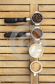 Jar of coffee and coffee in cup on wood background, top view