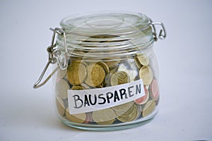 Jar with coins saying Bausparen building saving