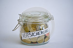 Jar with coins saying Versicherung insurance