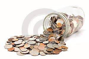 Jar of Coins Spilled Onto A White Background photo