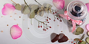 Jar for cookies, two cookies in form of heart and dog rose on light gray background. Valentine`s day.