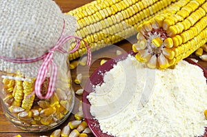 A jar with corn, flour and corn ear