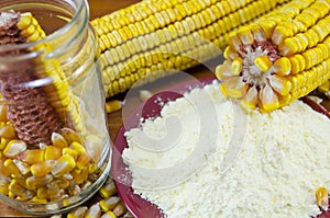 A jar with corn, flour and corn ear