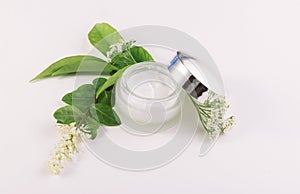 Jar of cream for skincare with herbs and flowers